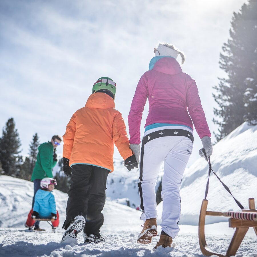 Famiglia slittando in paesaggio invernale | © Manuel Kottersteger