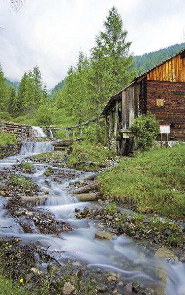Eine kleine Hütte neben einem kleinen Fluss im Wald im Sommer. | © TV St. Vigil